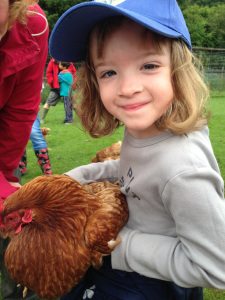 Mini Travellers - Coombe Mill, Cornwall - Fun on the farm Holding a chicken Coombe Mill, Cornwall - Fun on the farm www.minitravellers.co.uk