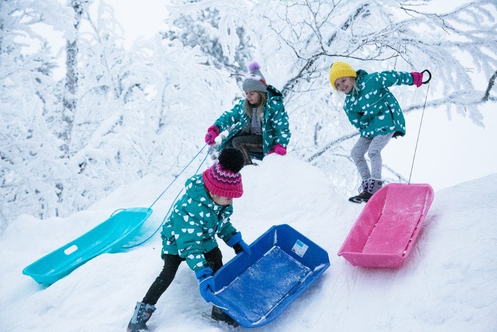 Playing with sledges in the snow - one of my top Winter activity ideas