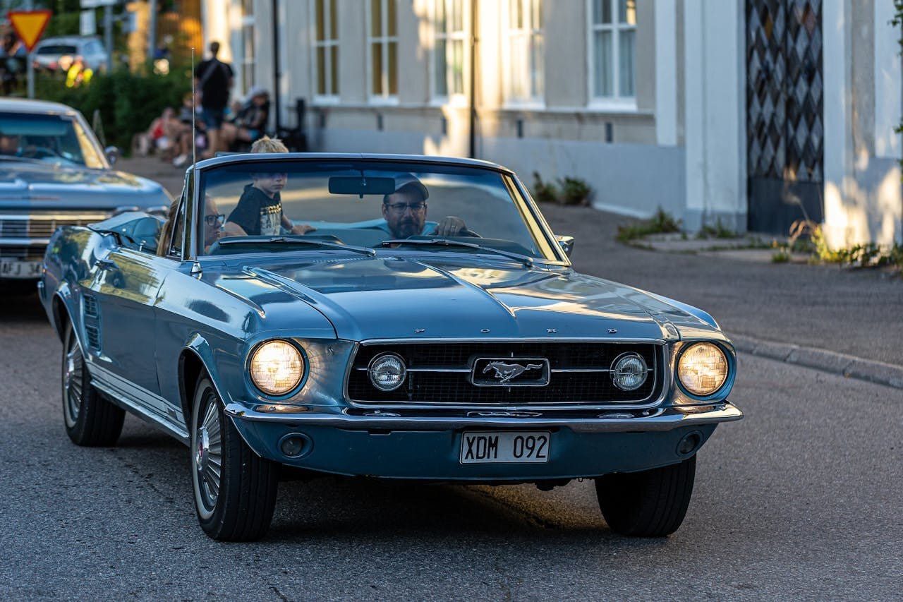 Family driving their open-top Ford Mustang for a memorable outing